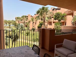 a balcony with a table and chairs and a building at Sun and Golf Holidays at Mar Menor Golf Resort in Torre-Pacheco +21 photos