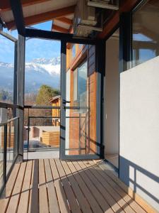 a room with a balcony with a view of a mountain at Cabañas Indómita in El Bolsón
