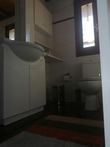 a bathroom with a sink and a toilet at Gerali house in Fáros +18 photos