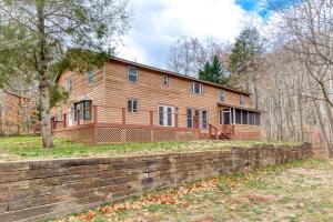 a large wooden house with a brick wall at 4BR Lodge on Wolf Creek - Fishing, Hiking, New River Fun and Hokie Weekends in Pearisburg
