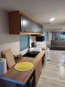 a kitchen with a desk with a computer on it at Domek holenderdki ZaCisze 2 in Augustów