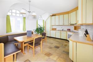a kitchen with a table and chairs in a room at Wohlfühlappartements Bayer in Bad Schallerbach +38 photos