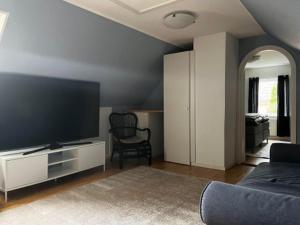 a living room with a large flat screen tv at Österlens Pärla in Borrby
