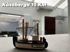 a small toy boat sitting on a table at Österlens Pärla in Borrby +2 photos