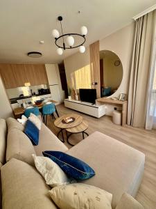 a living room with a couch and a table at Sorrento E 4 4 Sveti Vlas in Sveti Vlas