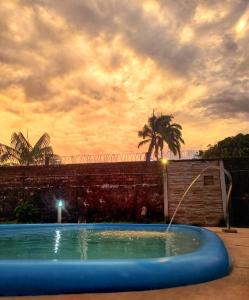 a large swimming pool with a water fountain at Praia do Paraíso in Mosqueiro +3 photos
