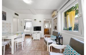 a living room with a table and a tv at 2 Bedroom Nice Home In Brodarica in Brodarica