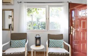 two chairs and a table in a room with a window at 2 Bedroom Nice Home In Brodarica in Brodarica