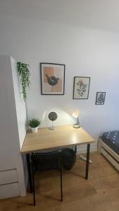 a desk with a lamp and a chair in a room at Warszawa Centrum Pokoje in Warsaw +17 photos