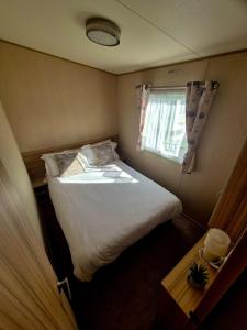 a bedroom with a large bed and a window at Whitstable Trieste - 3 Bedroom, sleeps 8 Pet friendly, family friendly in Seasalter +17 photos
