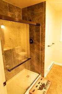 a shower with a glass door in a bathroom at Deer Crest Cabin 5Bedroom near JFBB ski area/Lake in Towamensing Trails +24 photos