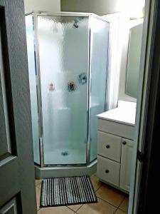a shower with a glass door in a bathroom at Wares Muskoka Lakes Estate in Gravenhurst +46 photos