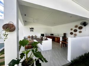 a living room with a dining table and a kitchen at Pinya Villas Elnido in El Nido