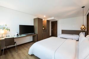 Ένα ή περισσότερα κρεβάτια σε δωμάτιο στο Hotel Poblado Alejandria