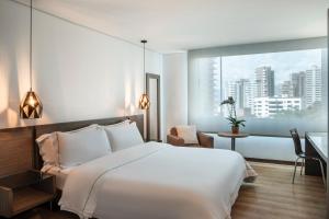 Ένα ή περισσότερα κρεβάτια σε δωμάτιο στο Hotel Poblado Alejandria