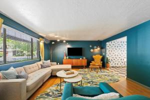 a living room with a couch and a tv at The East End Retreat in Boise