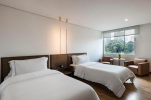 Ένα ή περισσότερα κρεβάτια σε δωμάτιο στο Hotel Poblado Alejandria