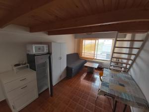 a small kitchen with a table and a microwave at Estudio pequeño in Andorra la Vella