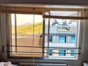a large window with a view of a building at Estudio pequeño in Andorra la Vella