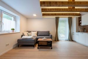 a living room with a couch and a table at Ferienwohnungen Traunblick & Salzweg in Bad Ischl