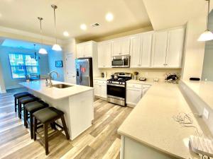 a kitchen with white cabinets and a sink and a counter at Venice court 21675 in Dewey Beach