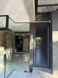 a glass door of a building with a potted plant at Temporarios Moritan 1B in Posadas