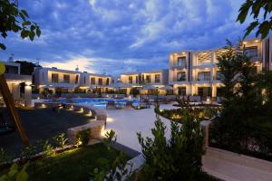 a large building with a pool and a resort at DARION Residence in Nikiti