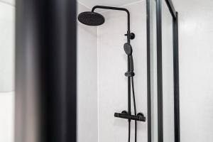 a shower in a bathroom with a shower head at 2 Bedroom House-Free Parking in Methil +12 photos
