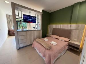 a bedroom with a bed with two towels on it at Temporarios Moritan 1B in Posadas +22 photos