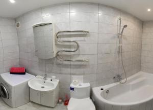 a bathroom with a toilet and a sink and a shower at Studio at Tsentralnyi Prospekt in Mykolaiv
