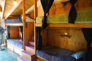 a couple of bunk beds in a room at Hostel Cosmo in El Bolsón