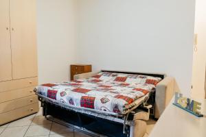 a bed in a room with a quilt on it at Quietude - Aosta in Aosta