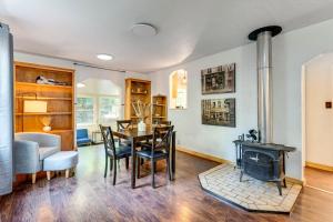 a living room with a table and a wood stove at Wine Country Cottage in Historic Fiddletown! in Fiddletown +21 photos