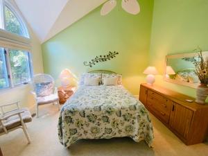 a bedroom with a bed and a dresser and a mirror at Spring lake 601 in Rehoboth Beach +14 photos