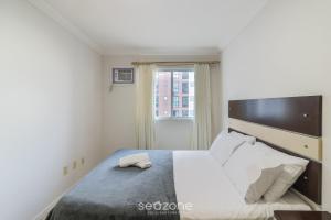 a bedroom with a large bed with a window at Apto 3Qtos Vista Mar a 130m da Praia RDK0801 in Perequê