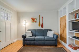 a living room with a blue couch and a tv at Maryland gardens 19c in Rehoboth Beach
