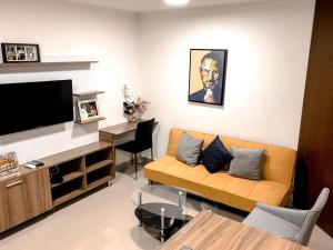 a living room with a couch and a television at Lofts Mediterraneo in Barranquilla
