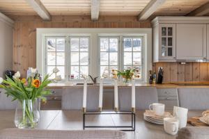a kitchen with a table with flowers on it at The national park is calling! in Garden