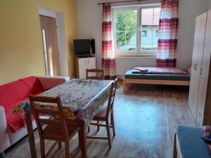 a living room with a table and a couch at Apartmány Dunice 2 - celý dům in Dunice