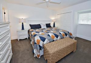 a bedroom with a bed and a chair in it at 1255 Harbour Town Club at The Sea Pines Resort in Hilton Head Island +19 photos