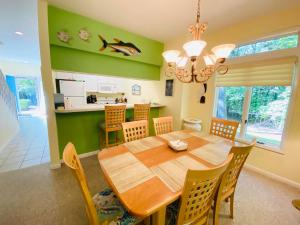 a dining room with a wooden table and chairs at Spring lake 601 in Rehoboth Beach