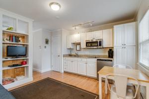 a kitchen with white cabinets and a table with chairs at Maryland gardens 19c in Rehoboth Beach +8 photos