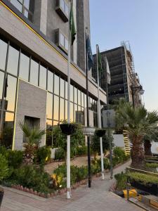 a building with flags in front of it at LE DIYAR Al Waha Hotel Riyadh in Riyadh