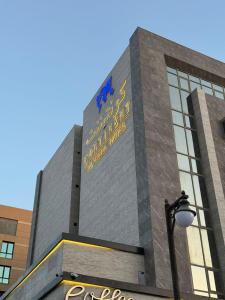 a building with a sign on the side of it at Continent Al Waha Hotel Riyad in Riyadh