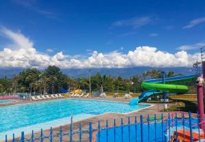 a large swimming pool with a water slide at Parque de la Familia in Montenegro