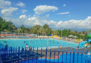 a large swimming pool with people in the water at Parque de la Familia in Montenegro +17 photos