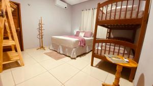 a bedroom with a bunk bed and a ladder at Casa com Piscina Privativa na Lagoa do Paraíso - John House Paradise in Jijoca de Jericoacoara +25 photos