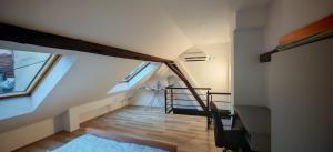 an attic room with a staircase in a building at NS Kutak in Novi Sad