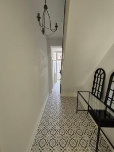 a hallway with a glass table and a chandelier at Cozy Double Room with 5 Minute Walk to Anfield Stadium ideal for Matchdays in Liverpool