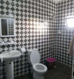 a bathroom with a toilet and a sink at appartement boukidan in Al Hoceïma +13 photos